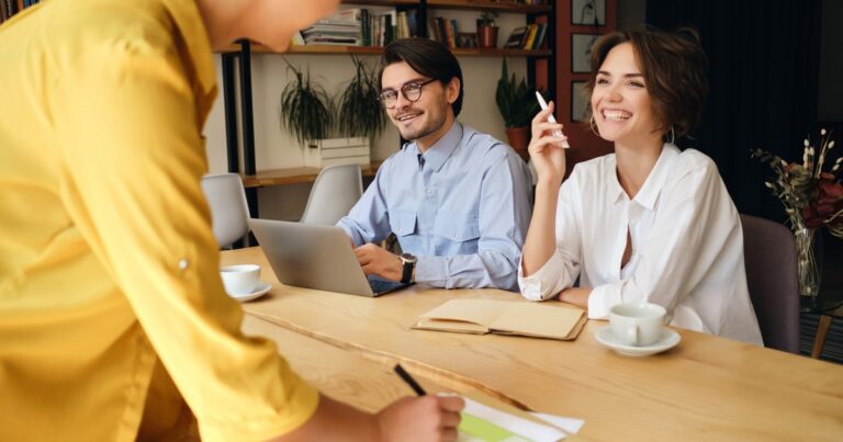 When to outsource HR in India shown by a cheerful small business team in a modern office